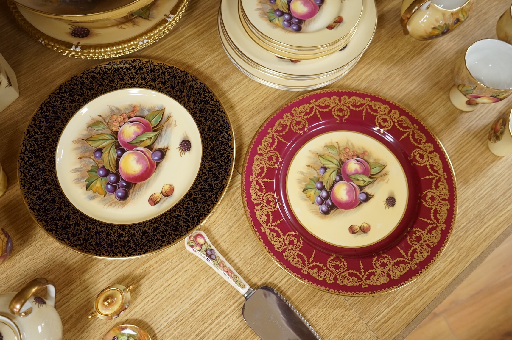 A collection of Aynsley ‘Orchard Gold’ fruit-painted tea/dinner wares and vases, largely signed by D Jones, largest 26cm in diameter